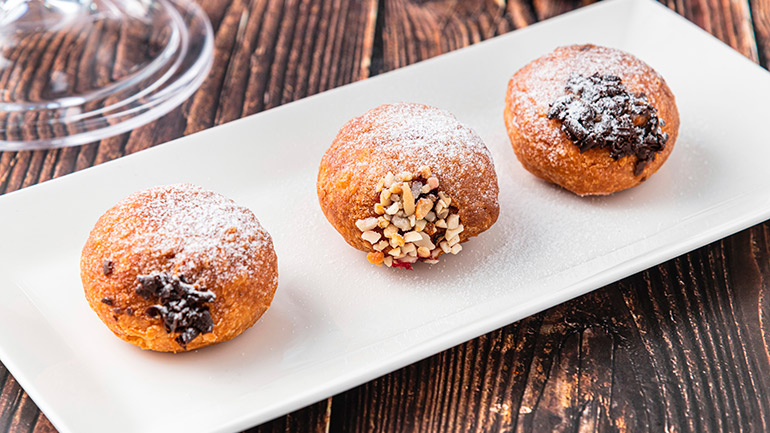 Bombolone or bomboloni is an Italian filled donut and snack food. German donuts - krapfen or berliner - filled with jam and chocolate